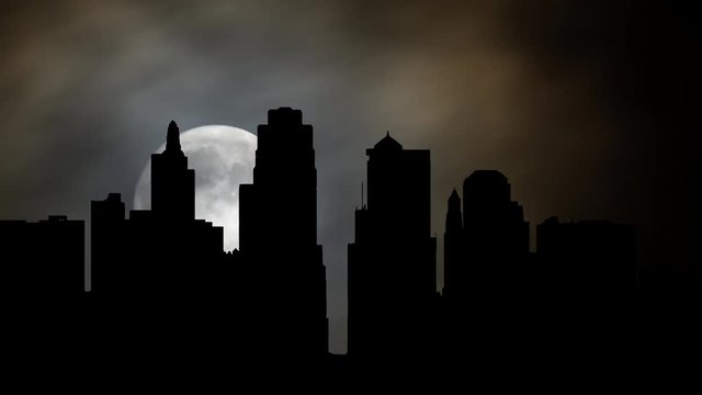 Kansas City skyline By Night with Full Moon, Clouds and Skyscrapers in Silhouette, Missouri, United State