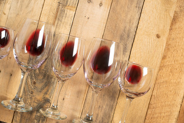 Red wine in transparent wine glasses on a wooden background. Bojole nouveau, wine bar, winery,...