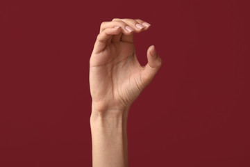 Fototapeta na wymiar Female hand showing letter C on color background