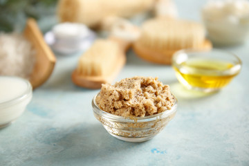 Bowl with body scrub on color background