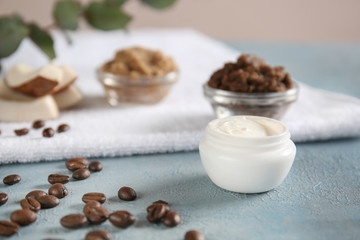 Jar of cream and body scrub on table