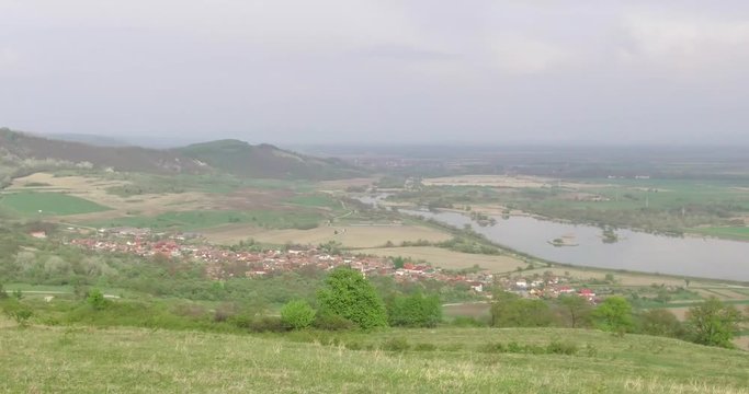 The image of a village in the center of Romania, a village bordered by the Olt River and the Fagaras Mountains