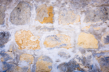 Eine alte verwitterte Steinmauer mit Vignette als Hintergrund