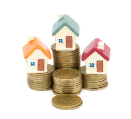Miniature house on stack coins using as property and business concep, isolated on white background, business house investment ideas concept with coin money stack. Growth of real estate business