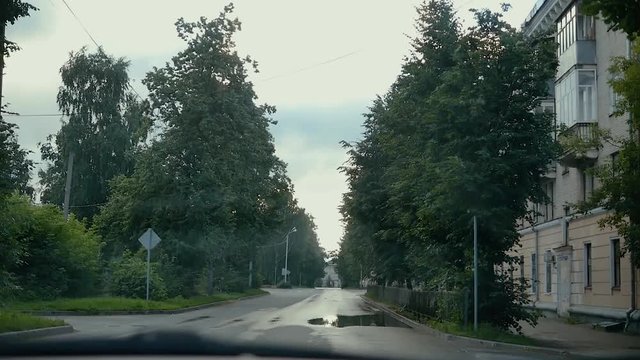 morning city without people view from the car going on the road summer spring trees