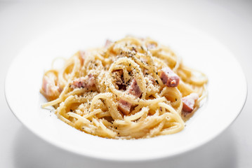 spaghetti pasta carbonara with bacon ham cream and kampot pepper