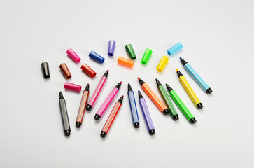 Multi colored felt tip pens on white background