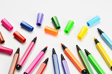 Multi colored felt tip pens on white background