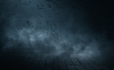 Background of empty dark street. Old brick wall, concrete floor. A spotlight at night illuminates an empty old wall. Smoke, fog