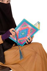 Portrait of a beautiful Muslim Arabic girl reading Al Quran