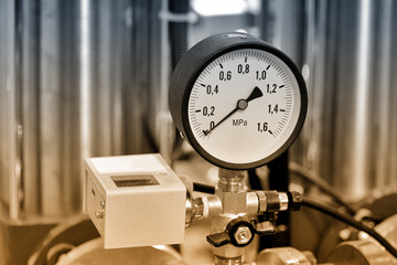 Hydraulic pressure gauge. Brown toned image