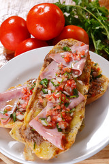 A mollete, is made with bolillos sliced lengthwise and partially hollowed, filled with refried beans, and topped with cheese and slices of jalapeño or serrano peppers.