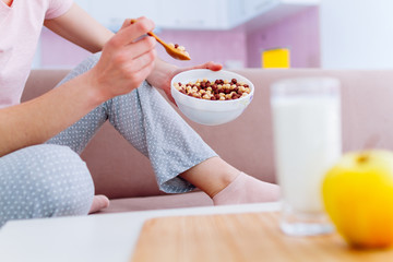 Cereals healthy crisp breakfast of bowl full of frosted chocolate balls, yellow apple and fresh...