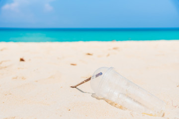 Obraz premium Glass and plastic tube, garbage on the beach thailand.