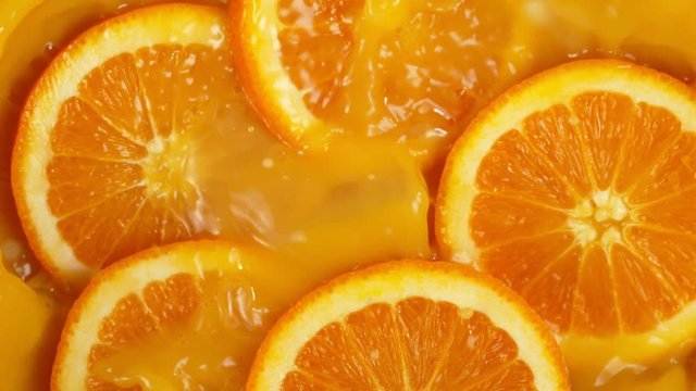 Super Slow Motion Shot of Orange Slices Splashing to Orange Juice at 1000fps.