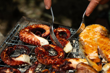 cooking fresh grilled octopus and fish
