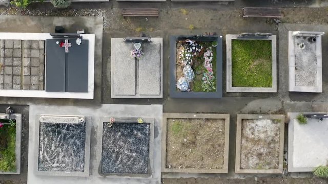 Cinematic Footage of Graveyard near the local Church. Very scary Cemetery with dark history. Filmed with a drone with bird eye view perspective. Filming in 4k very stable.