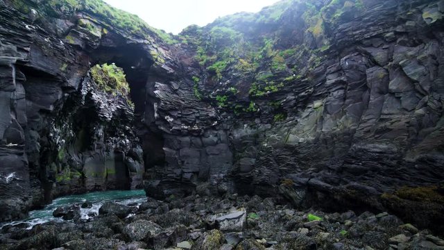 Rocky coastline landscape in Hellnar, Iceland. Hellnar was among the largest fishing villages beneath the Snaefellsjokull ice cap in West Iceland.