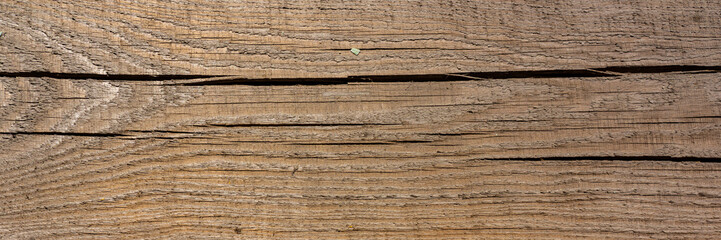 surface of a wooden bar covered with horizontal cracks.