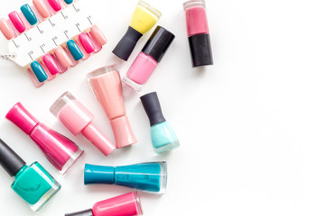 work desk at nail bar with nail polish and palette for manicure on white background top view mockup