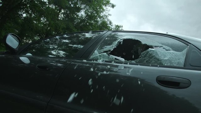 The policeman shoots out of the car. Fighting Shooting from the car. Slow Motion. 4K. UHD.