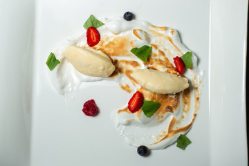 Dessert with whipped cream strawberries and raspberries.