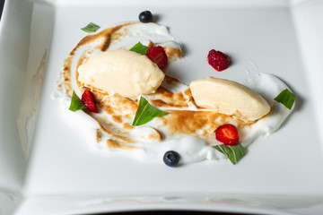 Dessert with whipped cream strawberries and raspberries.