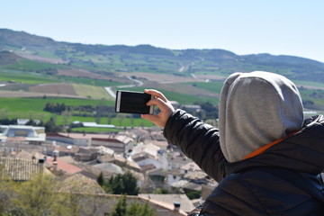 man taking panoramic pictures of the landscape