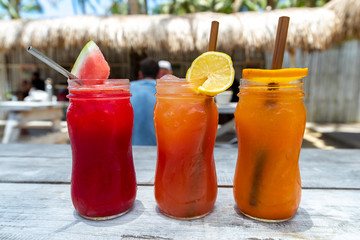 watermelon , lemon and orange juice on the table