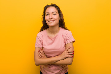 Obraz premium Young european woman isolated over yellow background laughing and having fun.