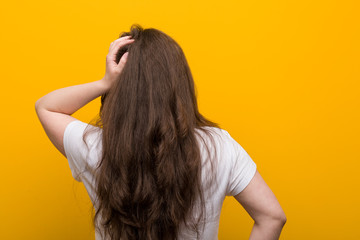 Obraz premium Young curvy plus size woman from behind thinking about something.