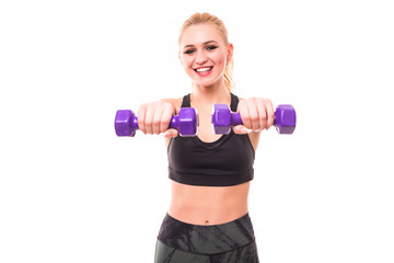Torso of a young fit woman lifting dumbbells on white background