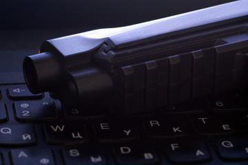 Black air gun on the keyboard.