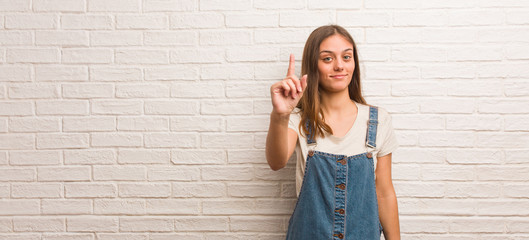 Young hipster woman showing number one