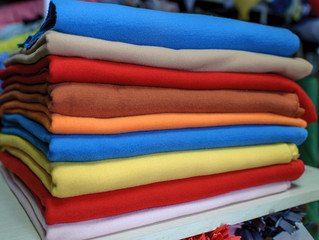 Fabric of different colors stacked on each other, forming a colored line