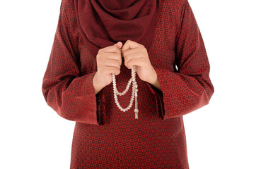 Young muslim woman holding a rosery or tasbih with isolated on white background