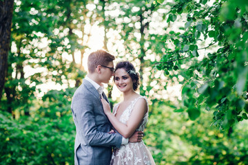 Bride and groom in a park. couple newlyweds bride and groom at a wedding in nature green forest 