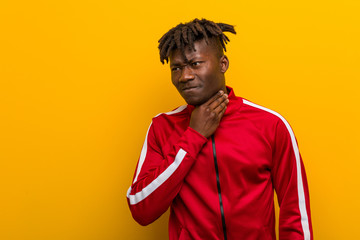 Young fitness black man suffers pain in throat due a virus or infection.