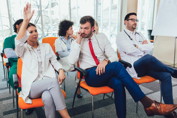Group of happy doctors on seminar in lecture hall at hospital