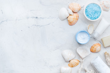 cosmetics with Dead Sea minerals and shells on marble background top view copy space