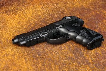 Black air gun on the metal grunge background.