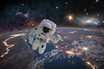Picture of astronaut in space. In background planet Earth. Elements of this image furnished by NASA - Image
