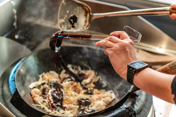 adding a sauce on frying pan
