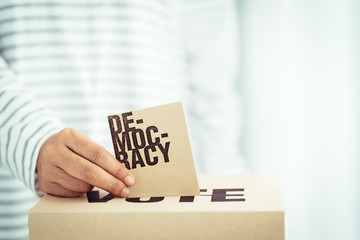 brown paper insert in vote box, bright future of democracy concept