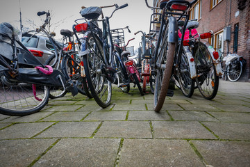 Fototapeta na wymiar chaotically parked abondoned bicycles on the streets of the Netherlands