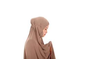 Asian female muslim praying isolated on white background.