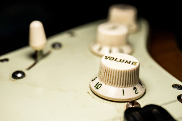 Details of electric guitar relic with macro dark background