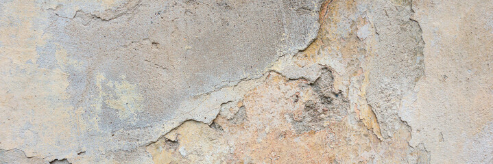 Old Wall With Peel Grey Stucco Texture. Retro Vintage Worn Wall Background. Decayed Cracked Rough Abstract Wall Surface.