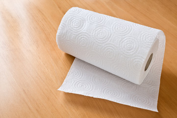 Paper towel roll on wooden the table.