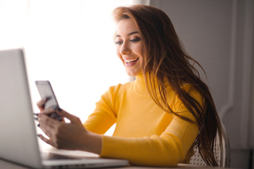 Pretty young woman checking her smartphone.